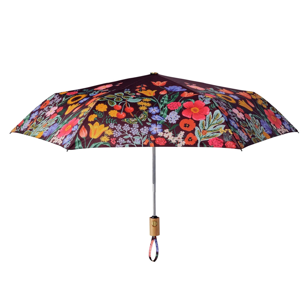 Rifle Paper Co. Blossom colorful floral print on black background automatic umbrella with wood handle, side view.