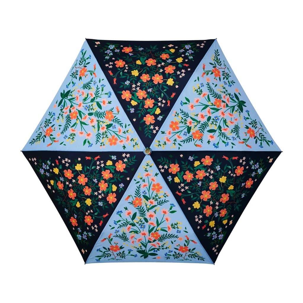 rifle paper company umbrella with wildwood floral print on sky blue and navy blue colorblock panels, open, top view.