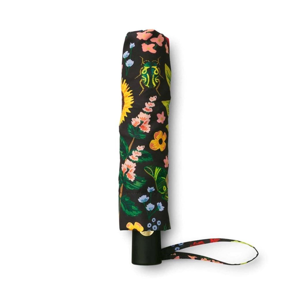 rifle paper company umbrella with curio floral and bug print on black panels, in matching pouch.