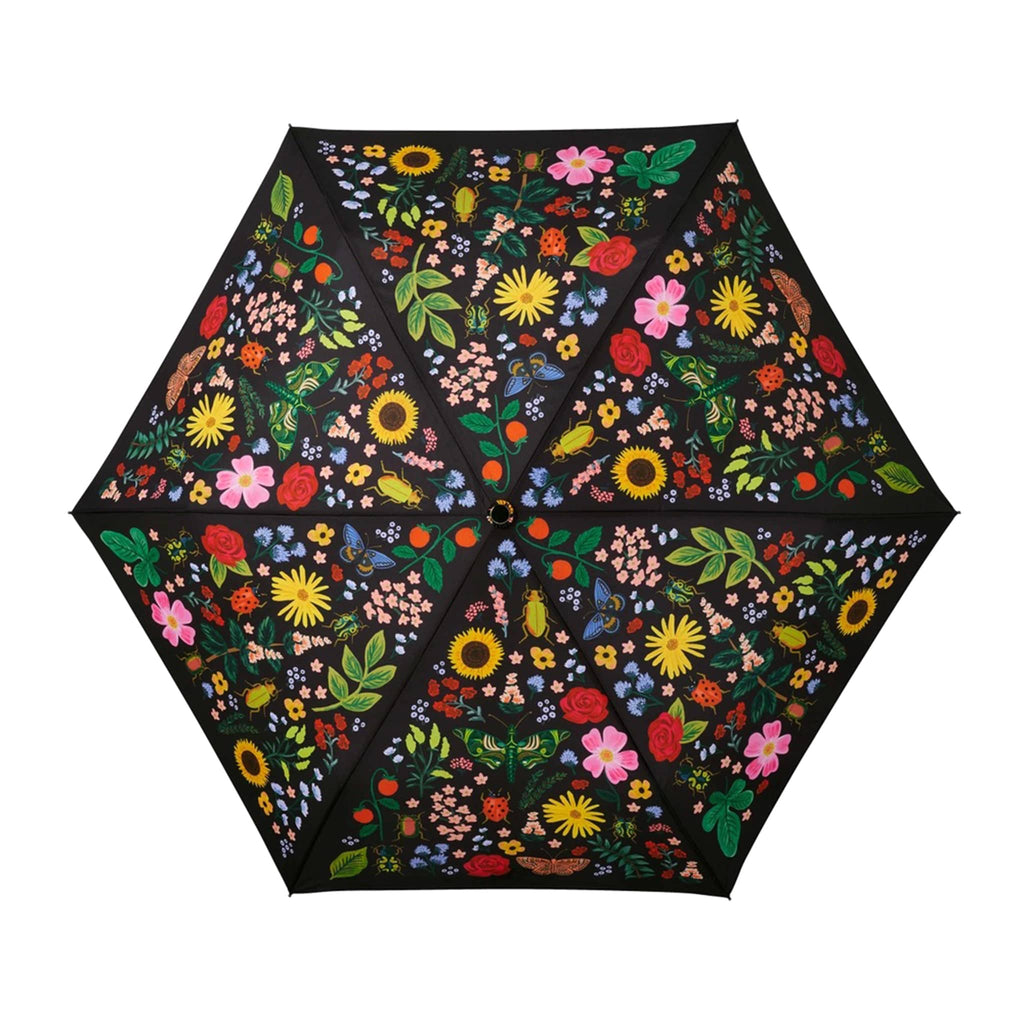 rifle paper company umbrella with curio floral and bug print on black panels, open, top view.