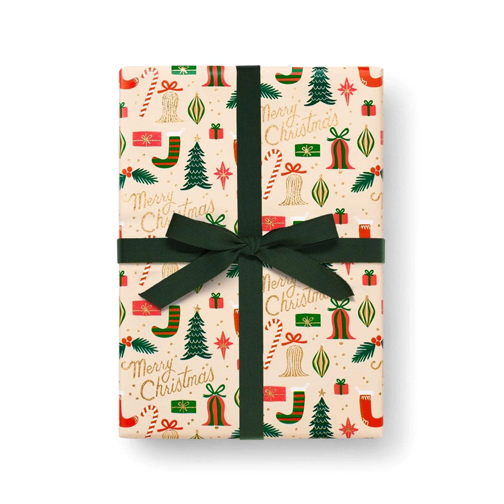 A box gift wrapped with Rifle Paper Co. Deck the Halls holiday Christmas wrapping paper and finished with a dark green velvet ribbon bow.