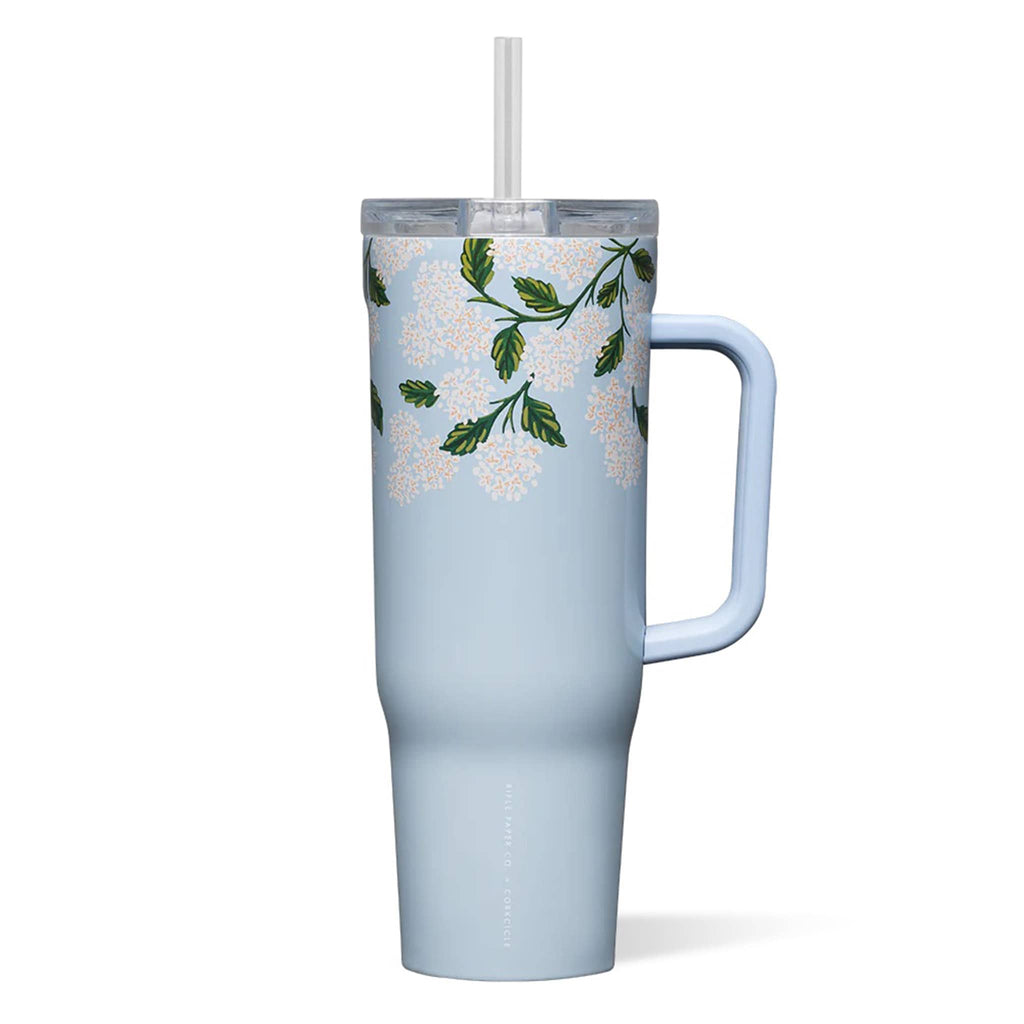 Rifle Paper Co. x Corkcicle 40 ounce insulated stainless steel cruiser cup with clear lid and straw and the Blue Hydrangea floral print on a light blue background.