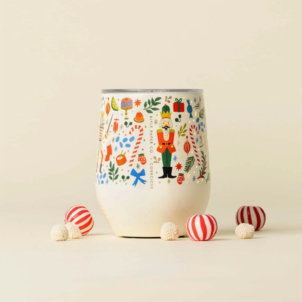 Rifle Paper Co x Corkcicle Nutcracker 12 Ounce Stemless Insulated Cup on ivory background with candies.