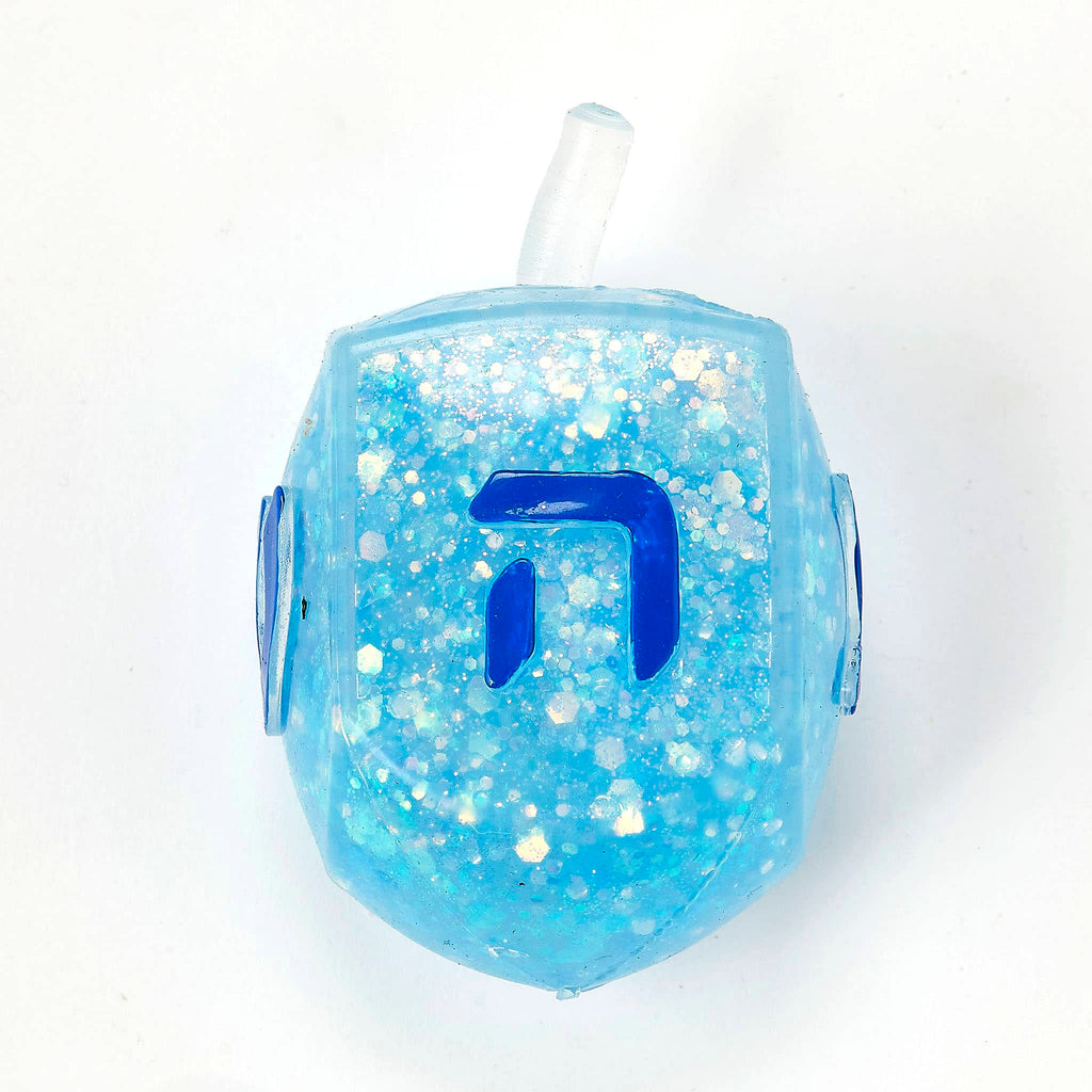 Blue glittery dreidel squish toy on a white background.