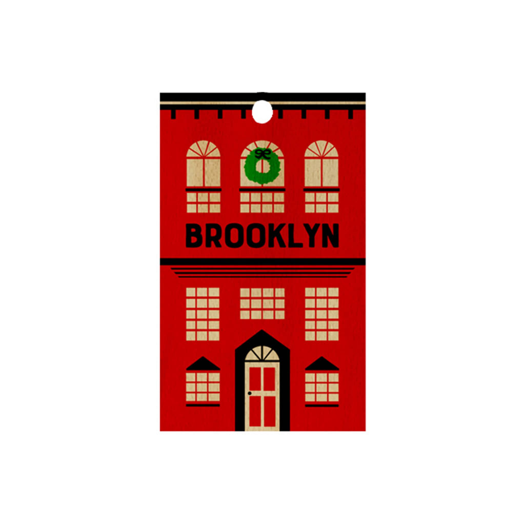 Red wooden ornament with a row house design and 'Brooklyn' text on a white background.