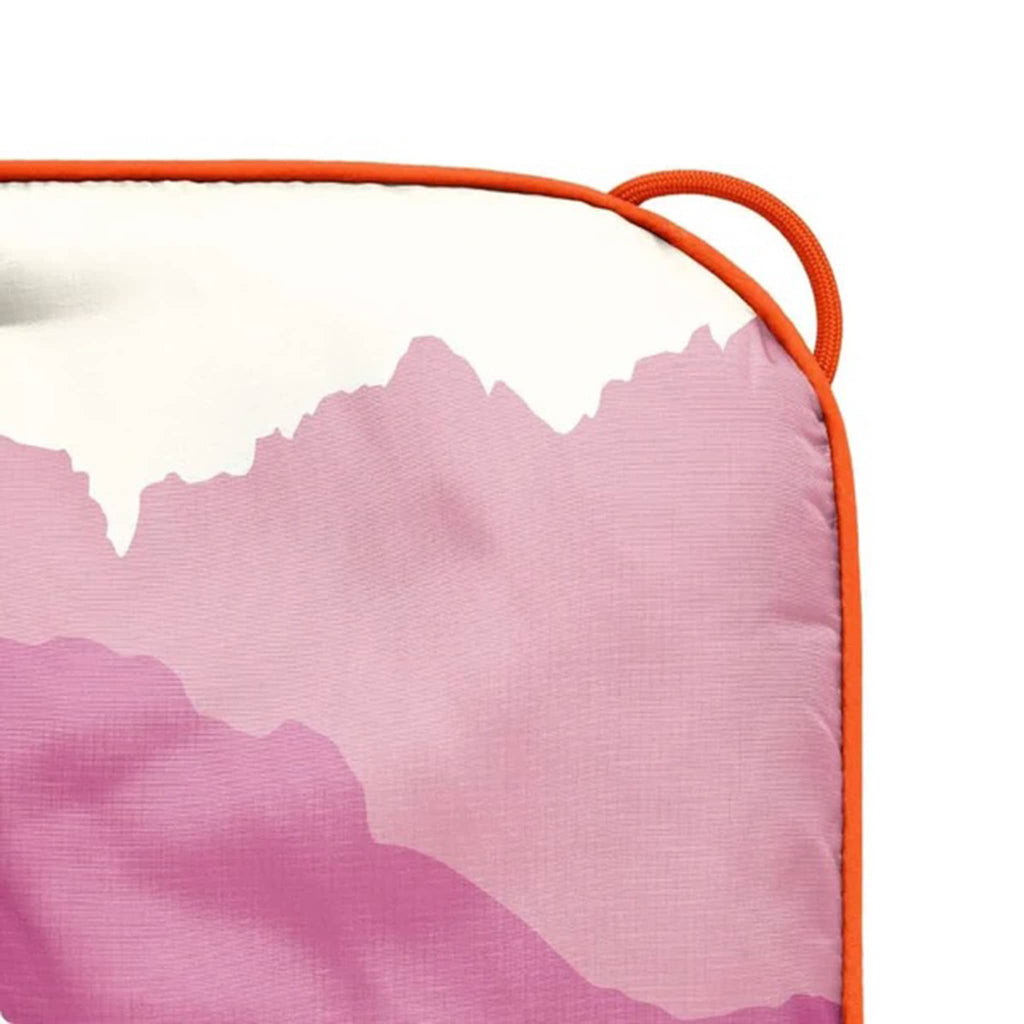 Close up of the Rumpl Teton Dusk original puffy blanket corner, on a white background.