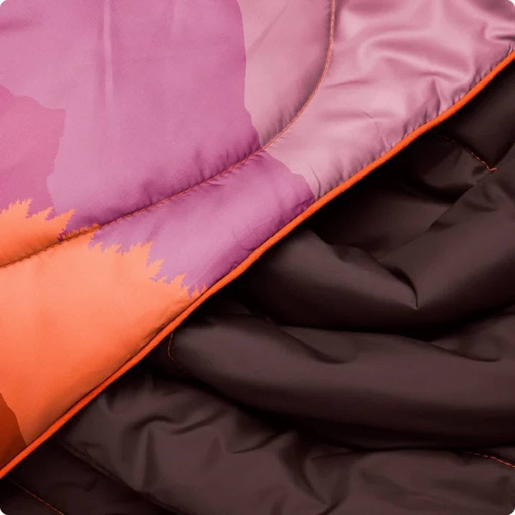 Close-up of a puffy blanket with purple, orange, and brown sections.