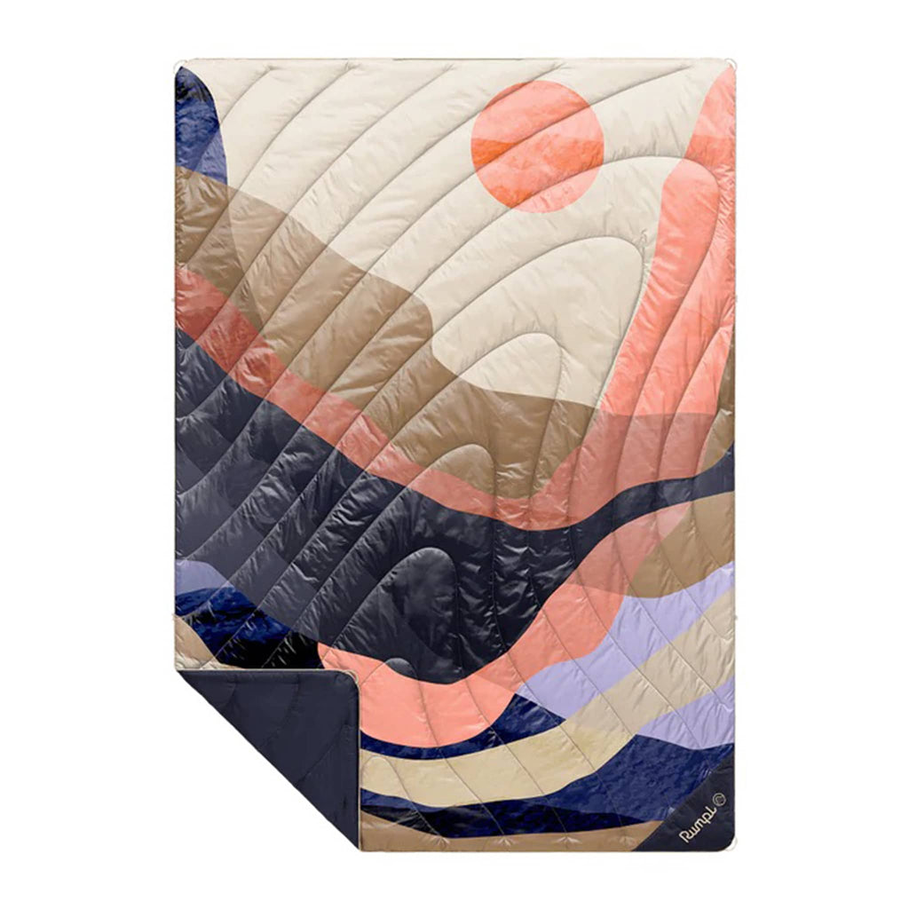 Rumpl Valley Dawn original puffy blanket with an abstract design in browns, purples and pinks, flat with corner folded back, on a white background.