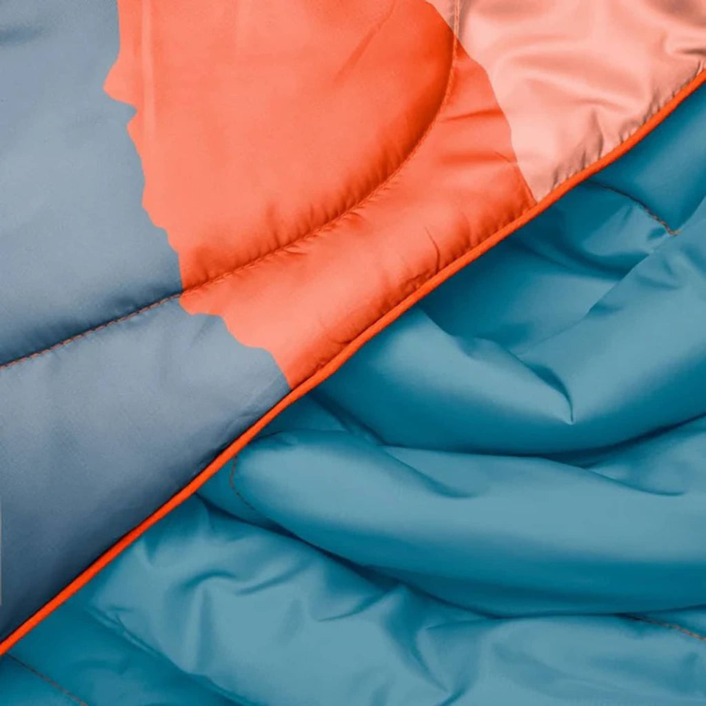 Close-up of blue and orange puffy blanket.