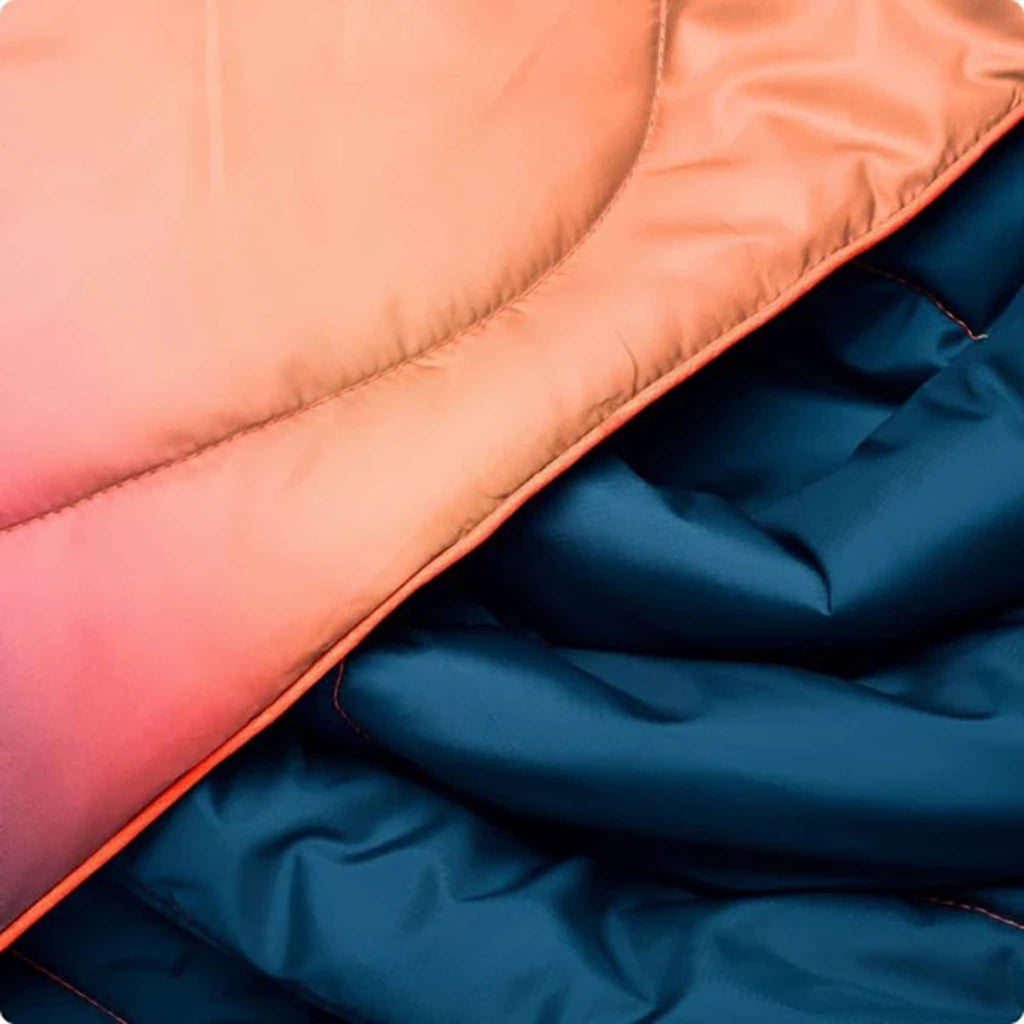 Close-up of a pink and blue quilted fabric.
