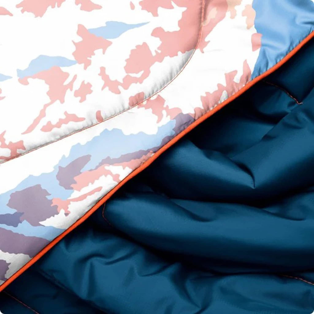 Close-up of a blue fabric with a pink and white patterned interior.