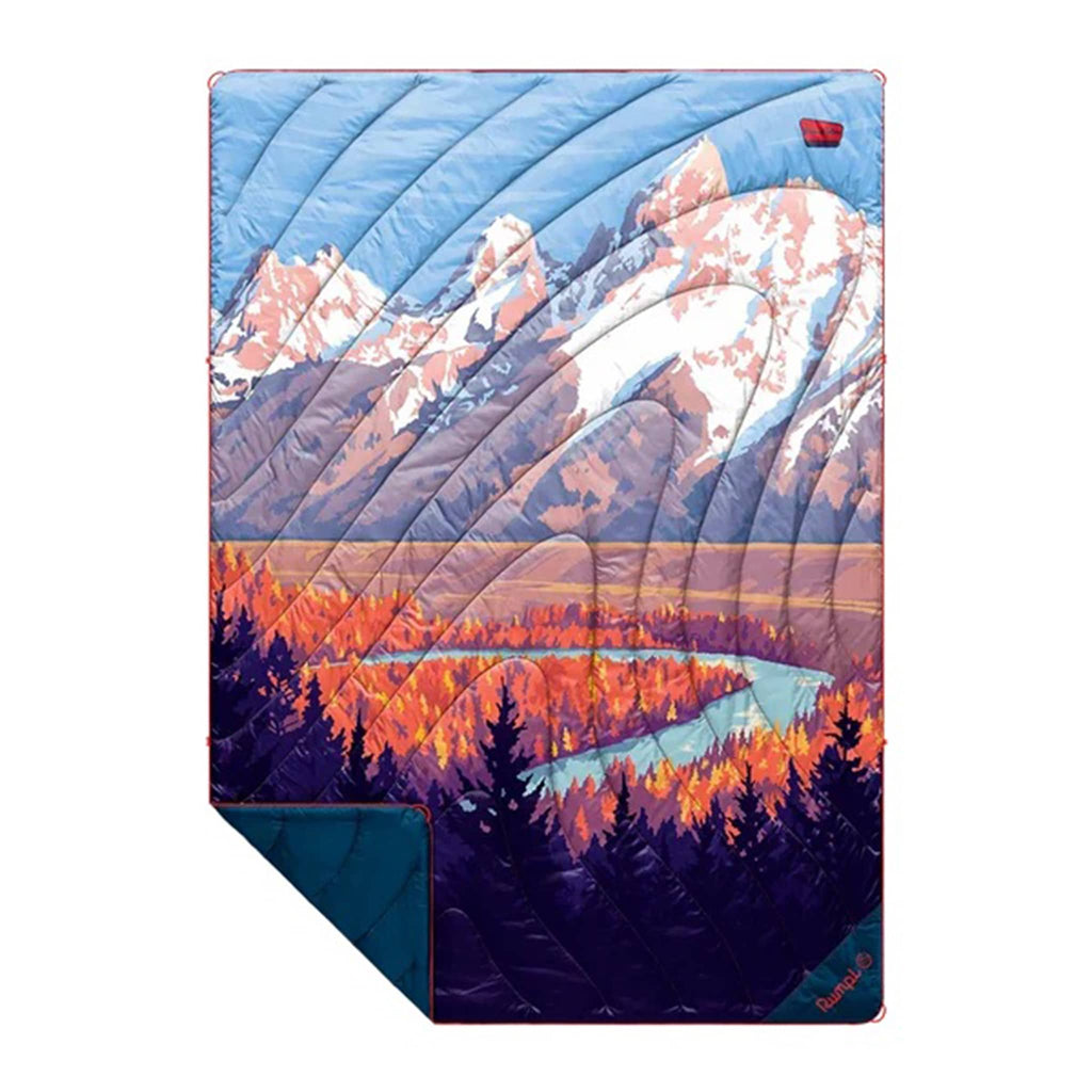 Rumpl Grand Teton National Park original puffy blanket with a mountain and lake landscape design, flat with corner folded back, on a white background.