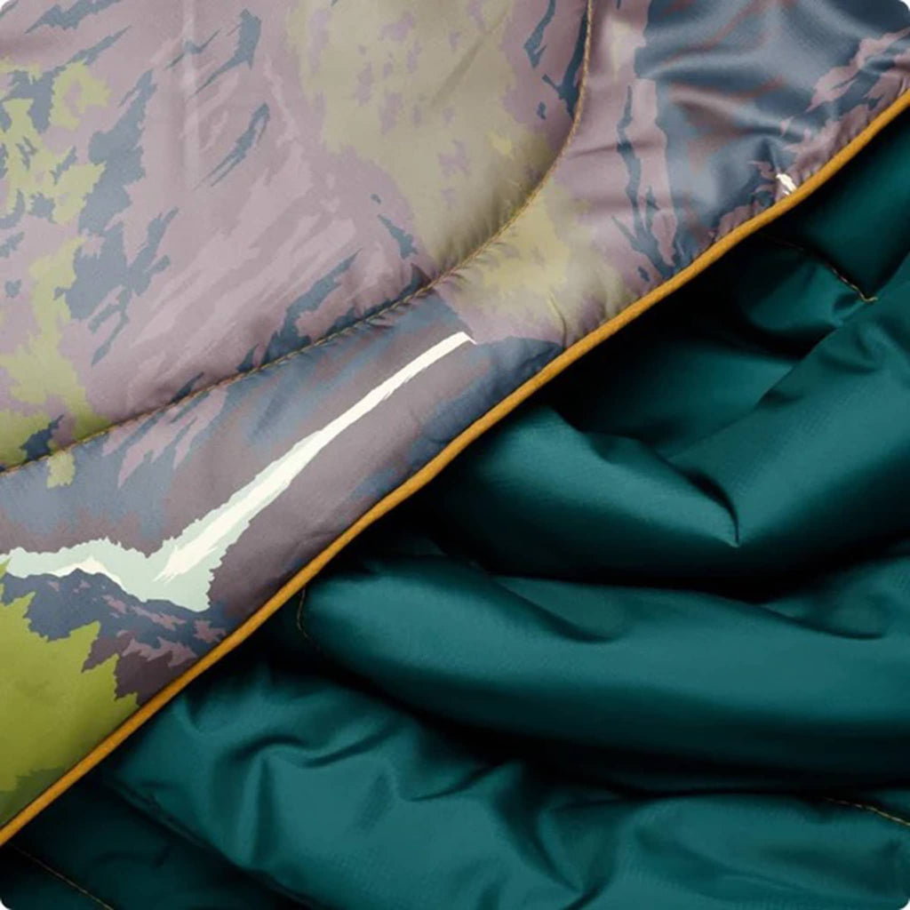 Close-up of a patterned with a teal fabric underneath.