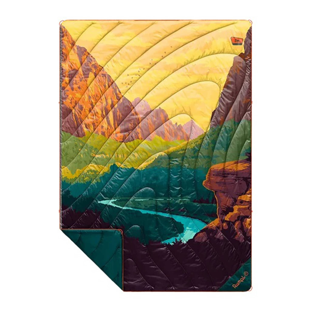 Rumpl Zion National Park original puffy blanket with a mountain landscape design, flat with corner folded back, on a white background.