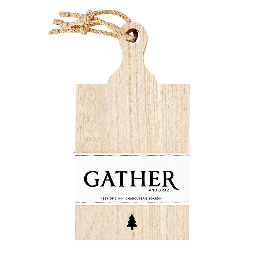 Santa Barbara Design Studio Gather and Graze set of 2 mini charcuterie boards made from paulownia wood with a tree graphic engraved at the bottom center of the board. Boards are tied together with jute rope and there is a white paper bellyband holding the boards together.