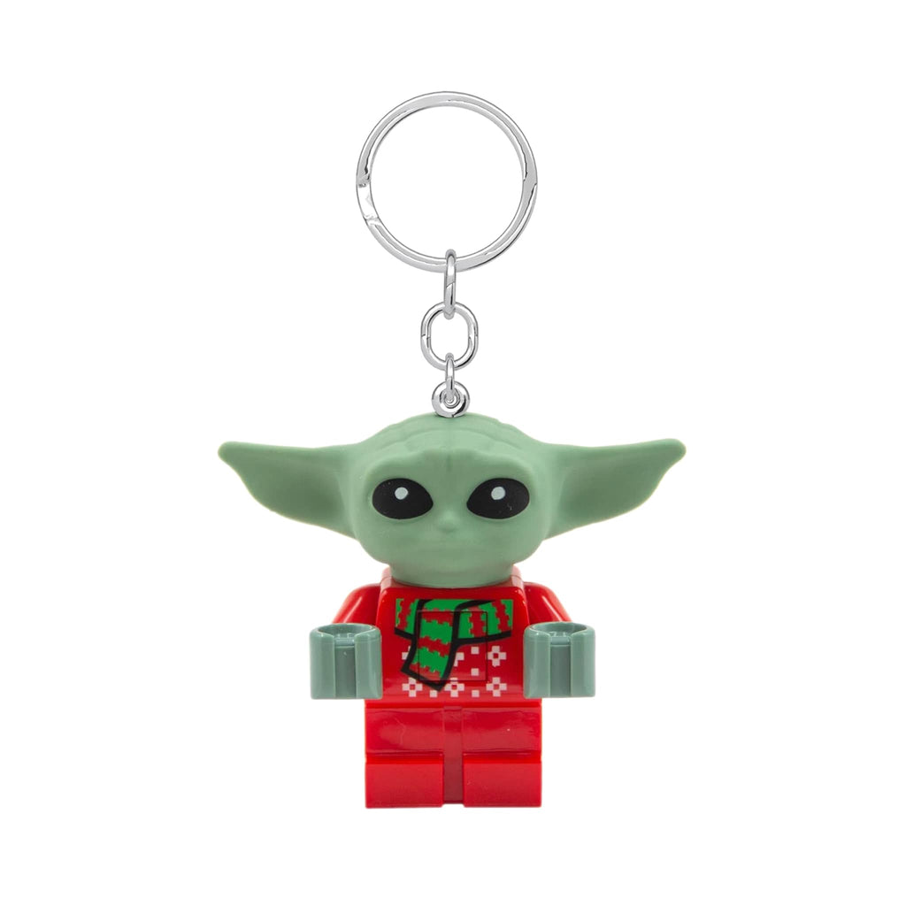 Keychain with a green character in a red holiday outfit on a white background.