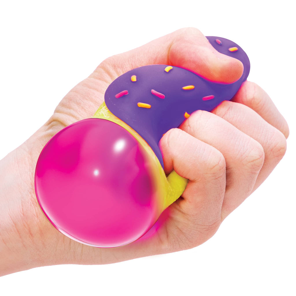 Schylling NeeDoh Jelly Dohnut fidget toy in hand being squeezed to show pink "jelly" popping out.