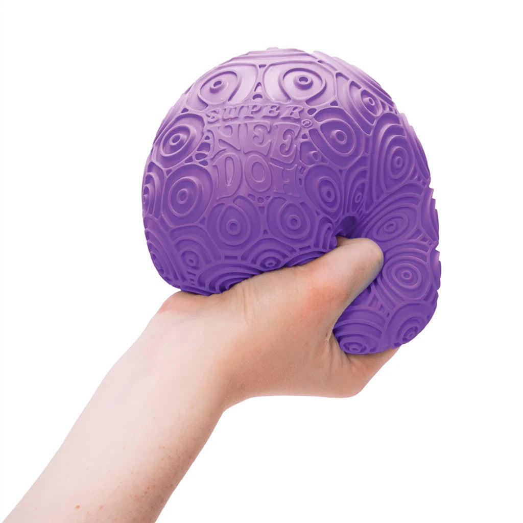 Schylling Super Needoh Ripples stress relieving large round purple fidget toy in hand for scale.