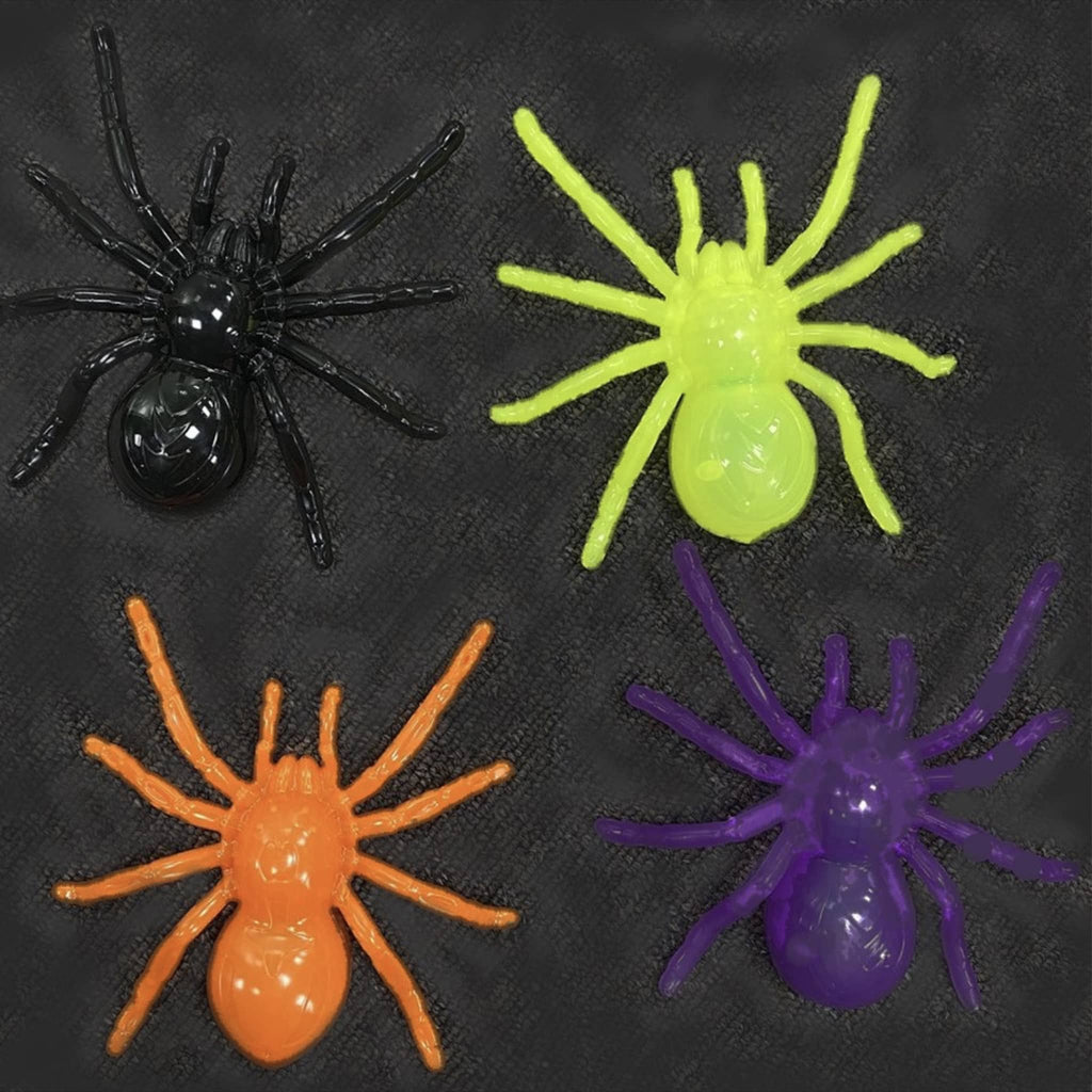 Four colorful spiders (black, green, orange, purple) with LED lights and suction cups, on a black background.