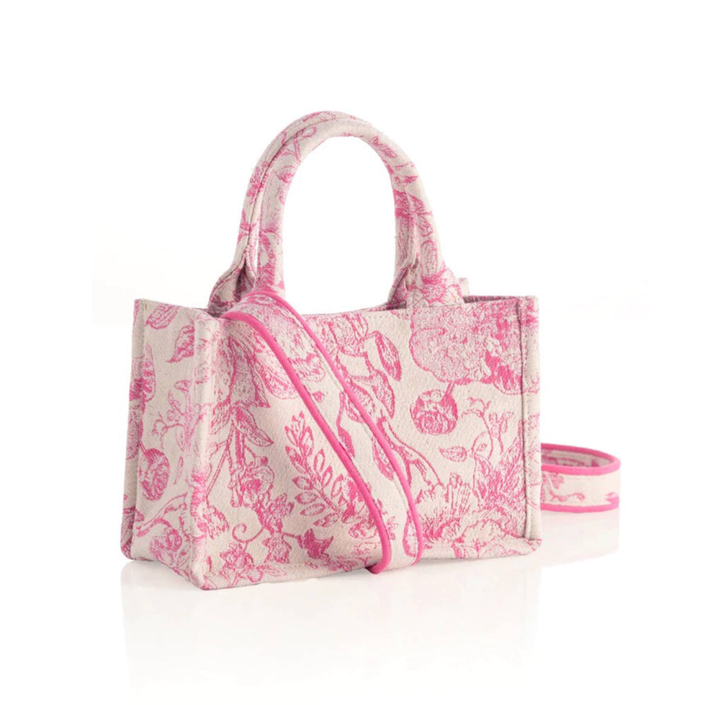 Shiraleah Mini Luma cotton canvas tote bag with pink floral print on white backdrop double handles and a detachable cross-body strap, front angle view.