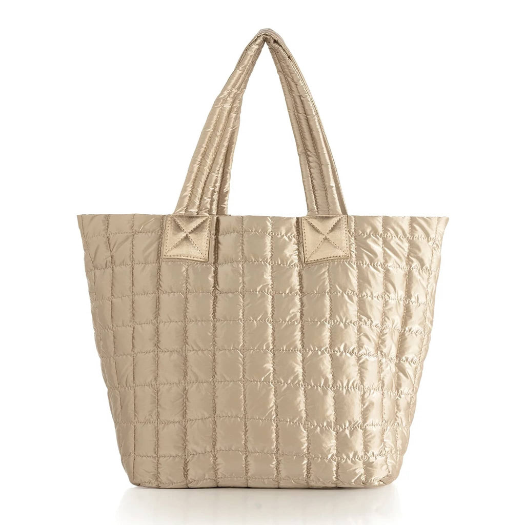 Matte gold quilted tote bag on a white background.