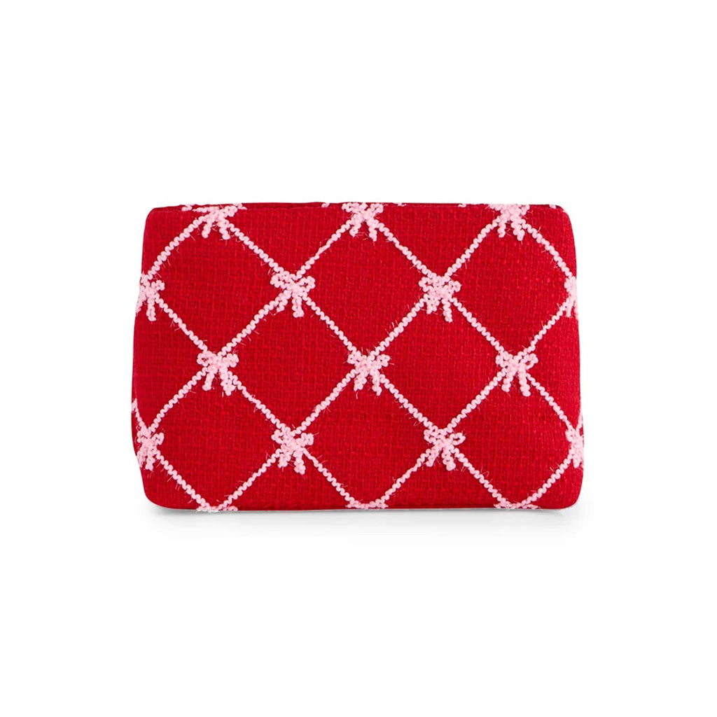 Red clutch with pink bow pattern on a white background.