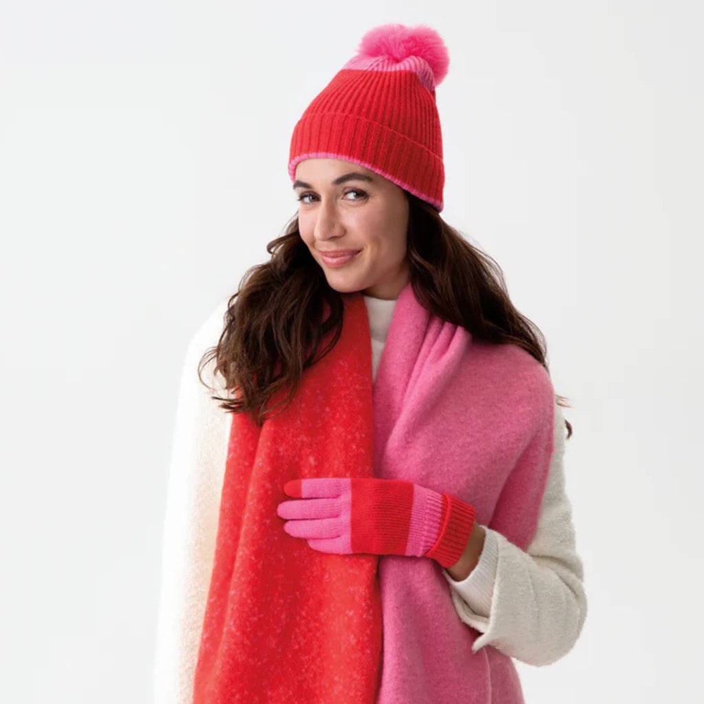 Shiraleah Sammy touchscreen compatible knit winter gloves in red and pink on model with matching hat and scarf.