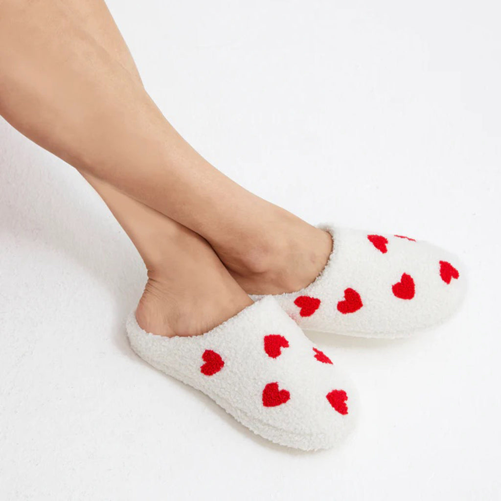 Shiraleah Hearts Slippers ivory plush close toed slippers with red hearts on models feet.