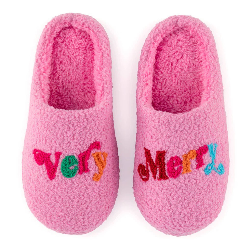 Shiraleah pink sherpa slippers with "very" and "merry" across the toe in colorful letters.