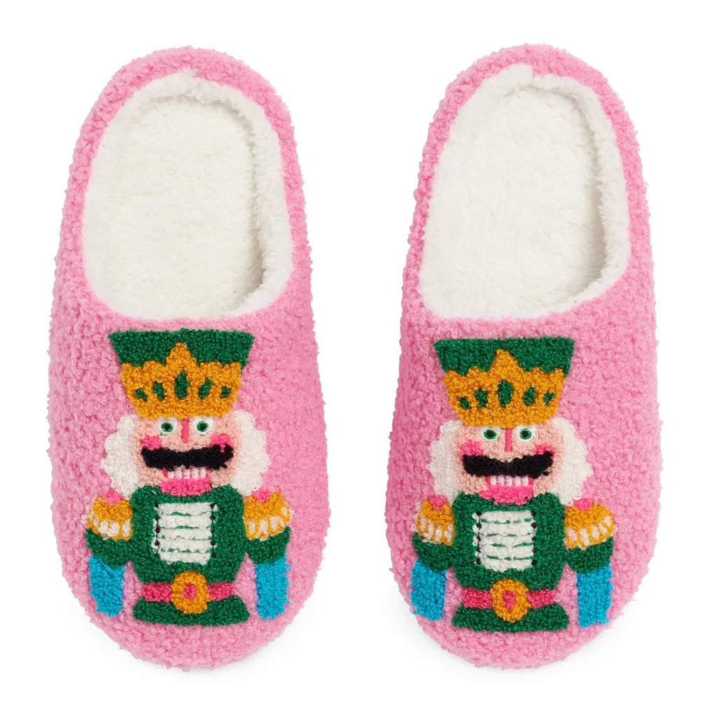 Pair of pink slippers with a Nutcracker design on a white background.