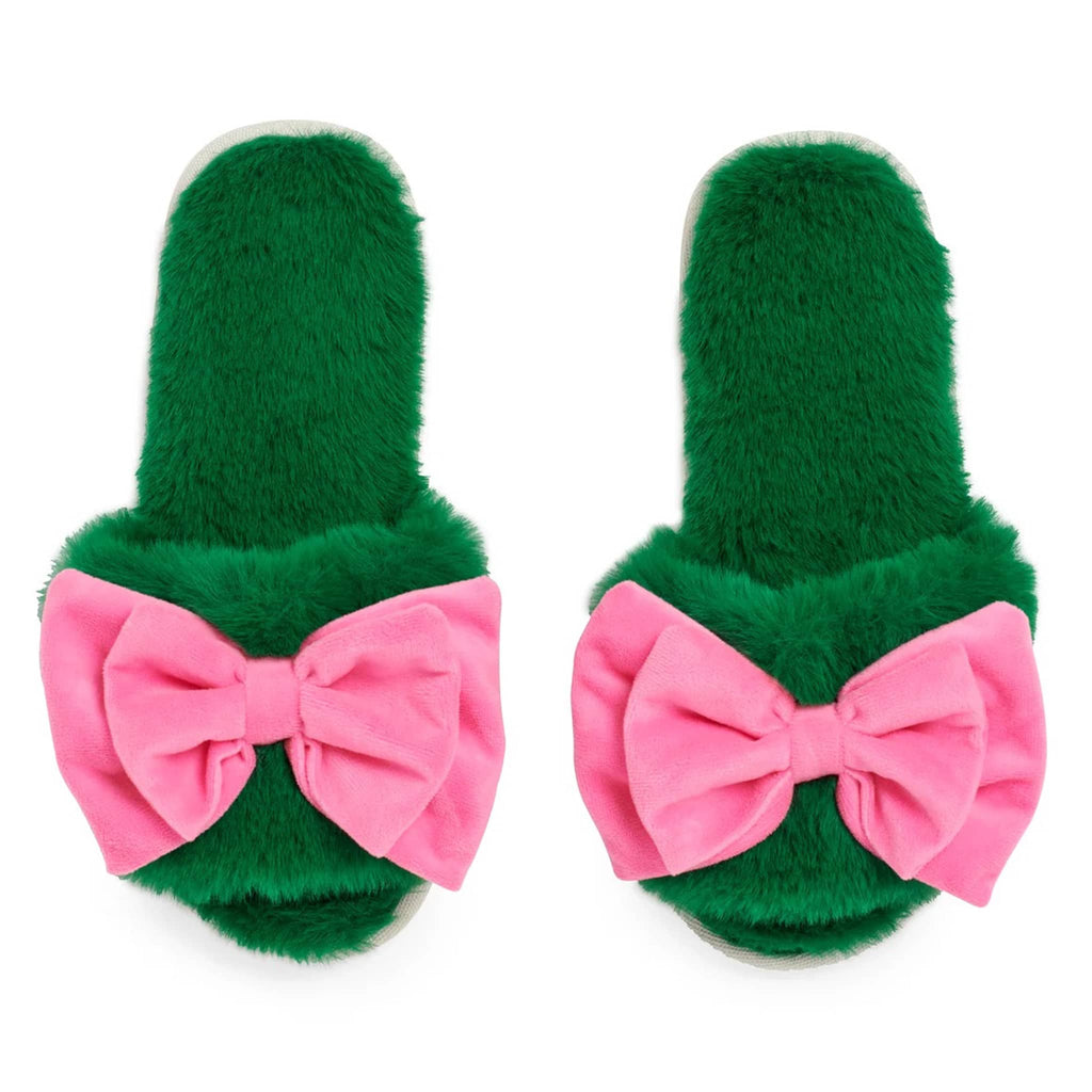 Green fuzzy slippers with pink bows on a white background.