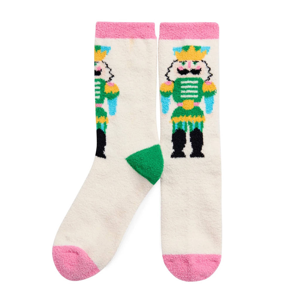 Pair of ivory socks with colorful nutcracker design and pink cuff and toe, on a white background.