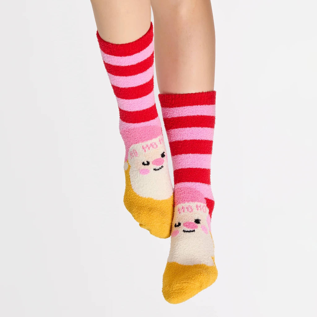 Pair of pink and red striped socks with yellow toes and a santa face, on a person's feet, on a white background.
