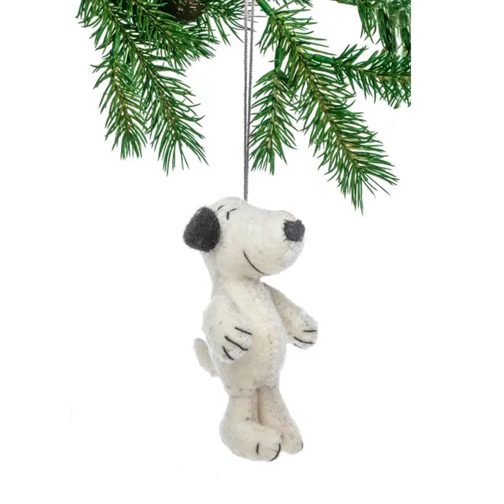 Felt Snoopy ornament hanging from a Christmas tree branch.