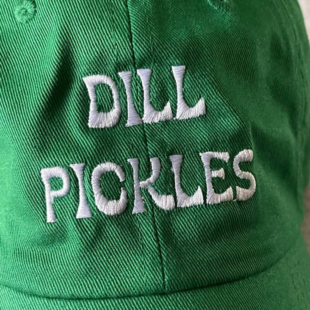 Silver Spider green unisex baseball cap with "dill pickles" in white embroidered letters on the front, detail of embroidery.