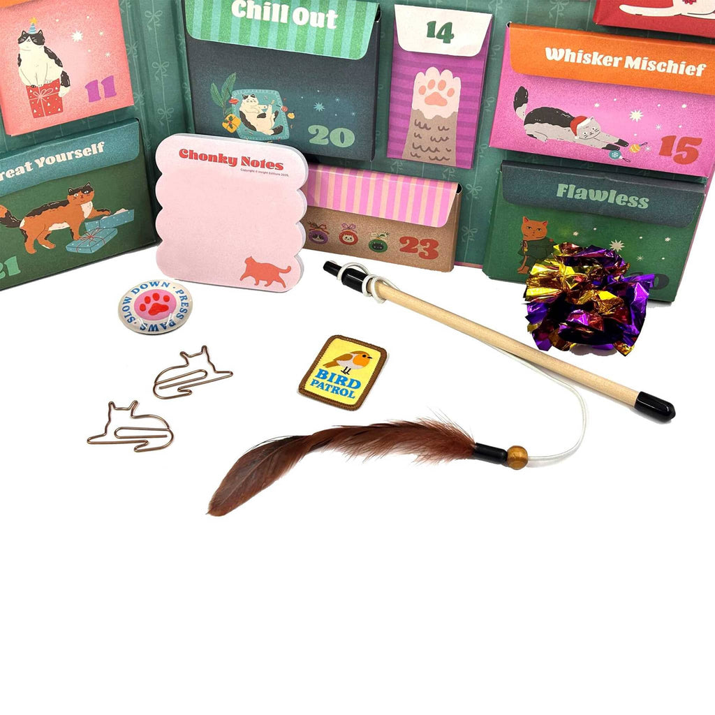 Collection of cat-themed products including cards, a feather toy, and a lanyard on a white background.