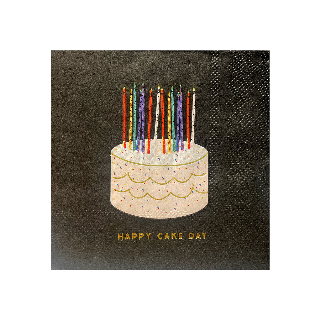 Slant Collections black square beverage napkins with "happy cake day" in gold foil lettering and colorful cake illustration.