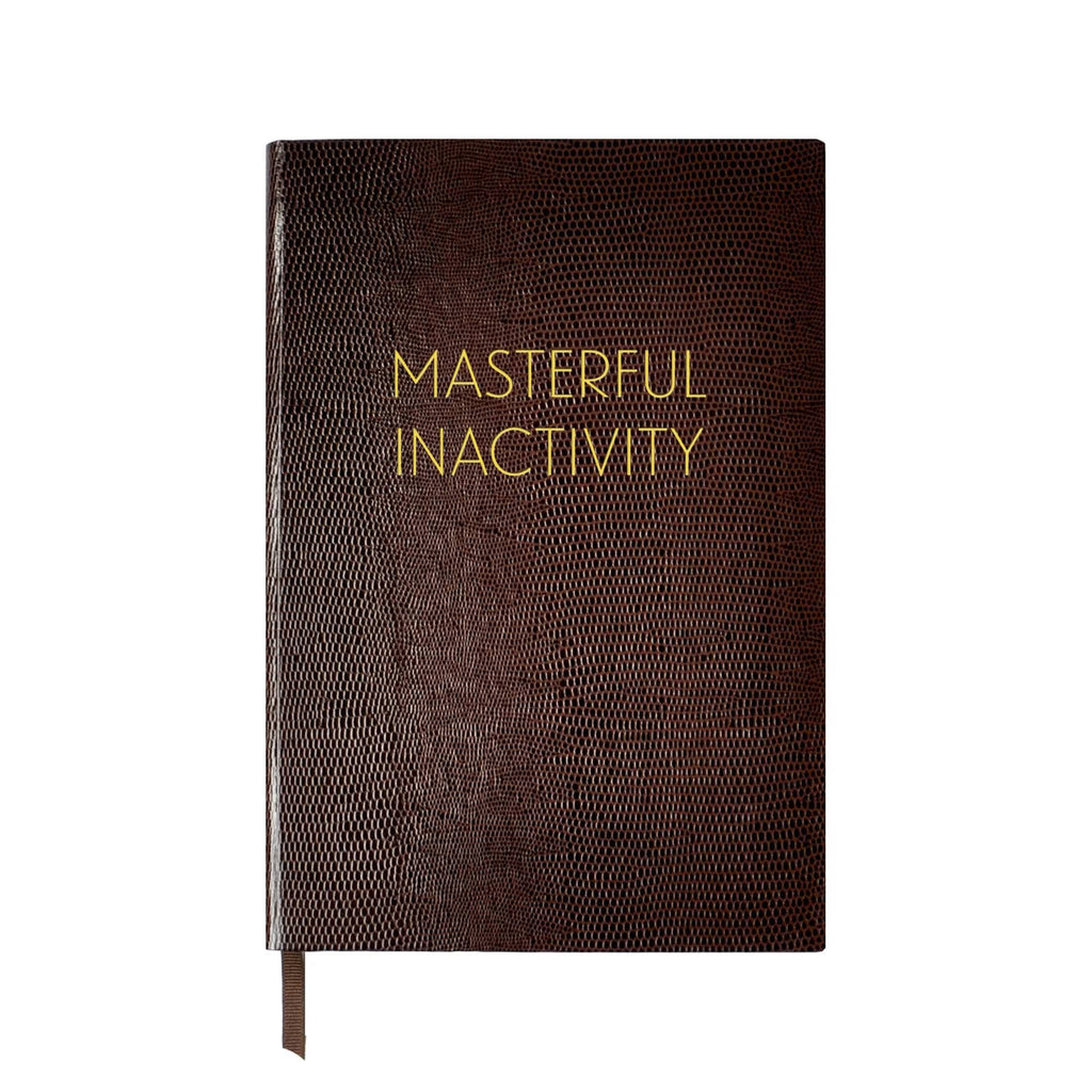 Front cover of a brown faux lizard notebook with "Masterful Inactivity" in gold foil lettering, on a white background.