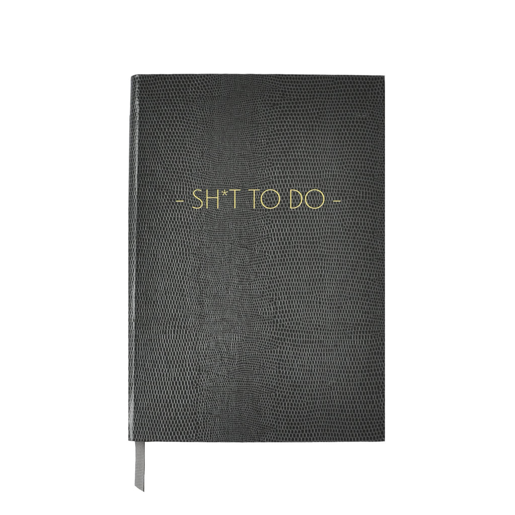 Front cover of a gray faux lizard notebook with 'SH*T TO DO' in gold lettering, on a white background.