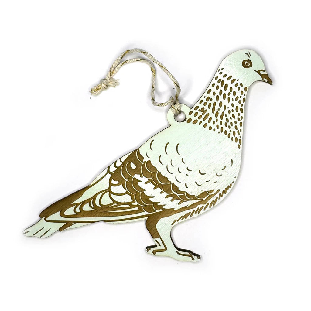 Decorative wood pigeon ornament with a string on a white background.