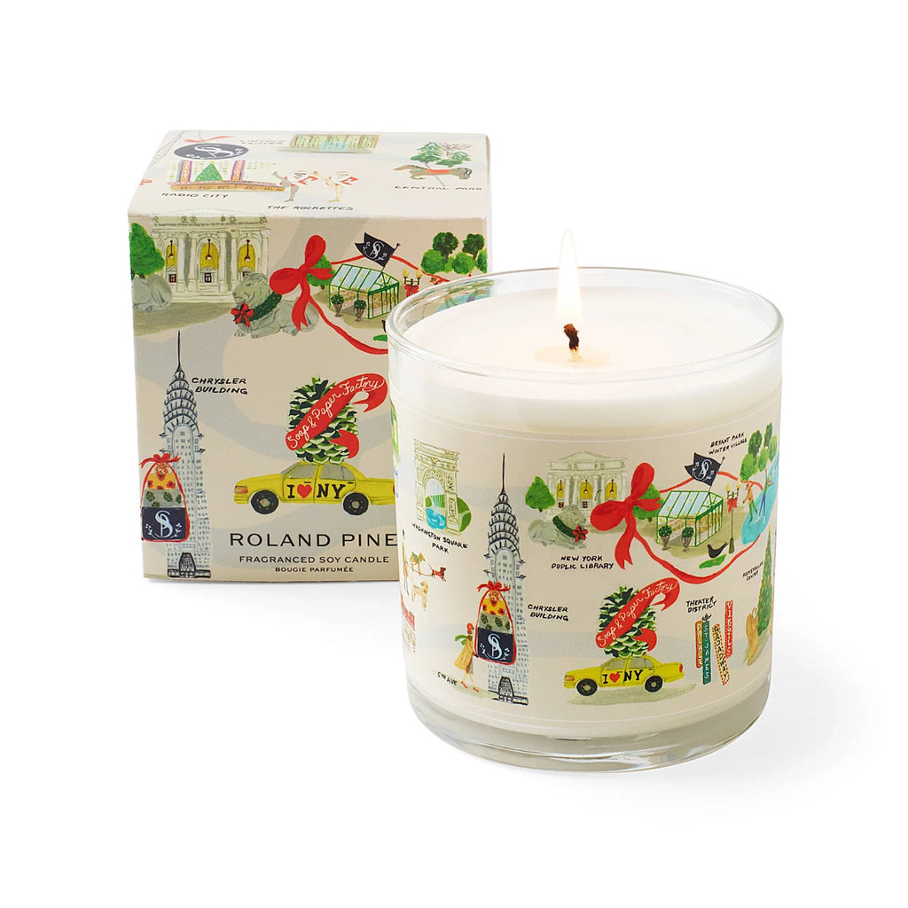 Candle with New York-themed design and matching packaging on a white background.