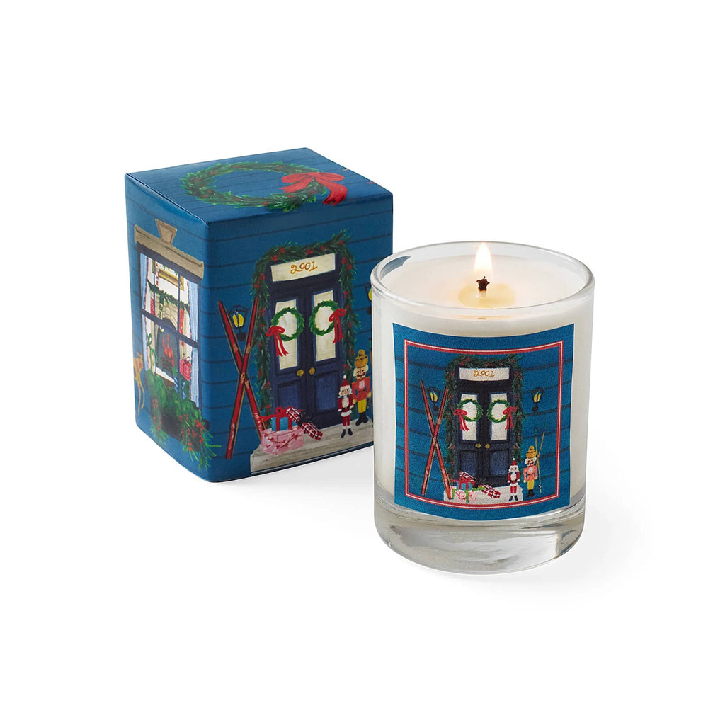 Candle with decorative label and matching box on a white background.