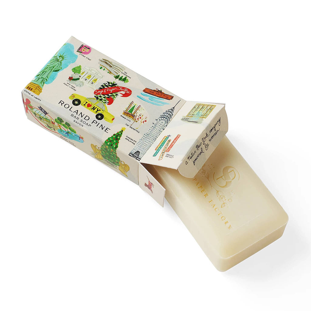 Bar of soap with a decorative packaging featuring illustrations and text on a white background.