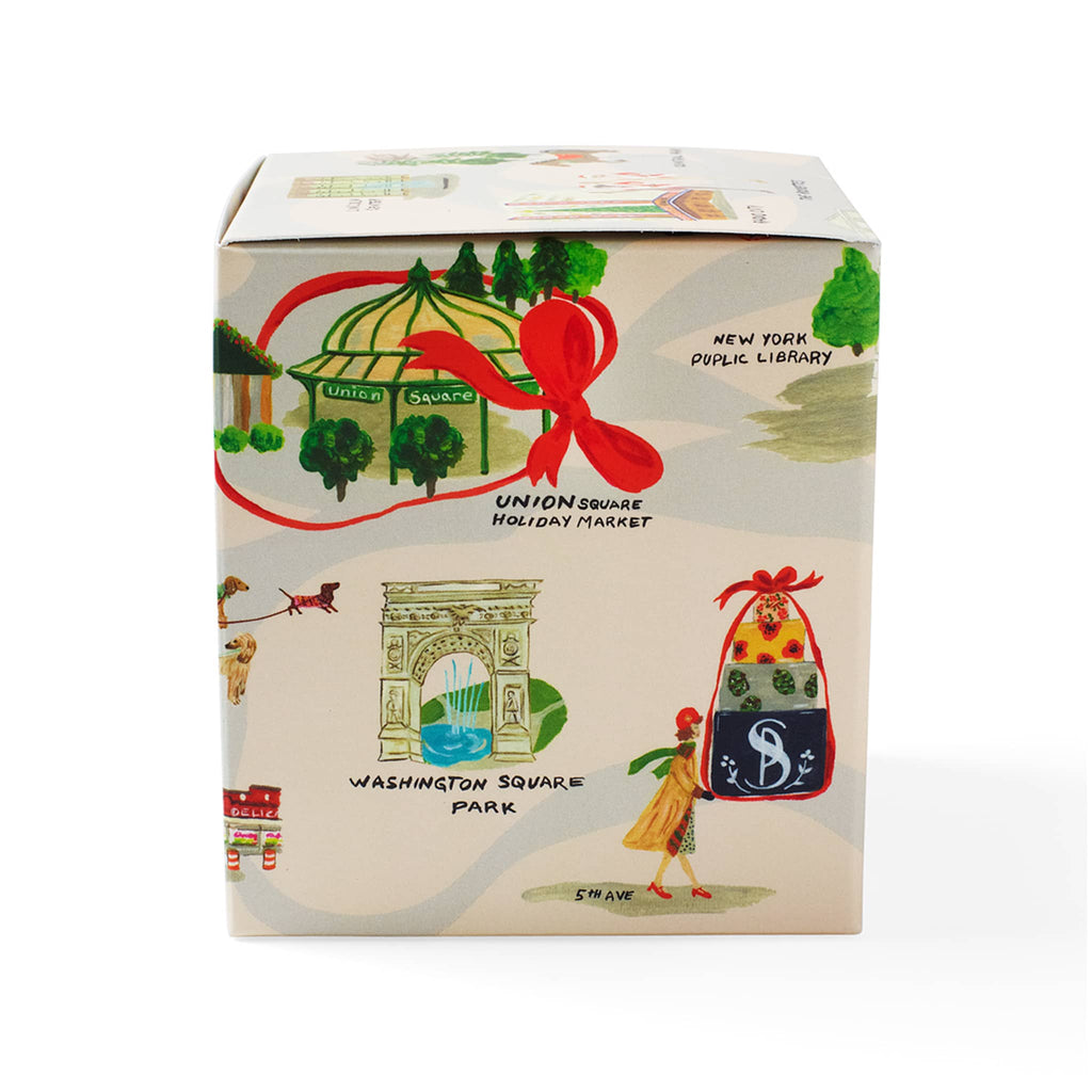 Soap & Paper Factory Roland Pine scented soy wax candle in gift box covered in NYC holiday illustrations, left side.