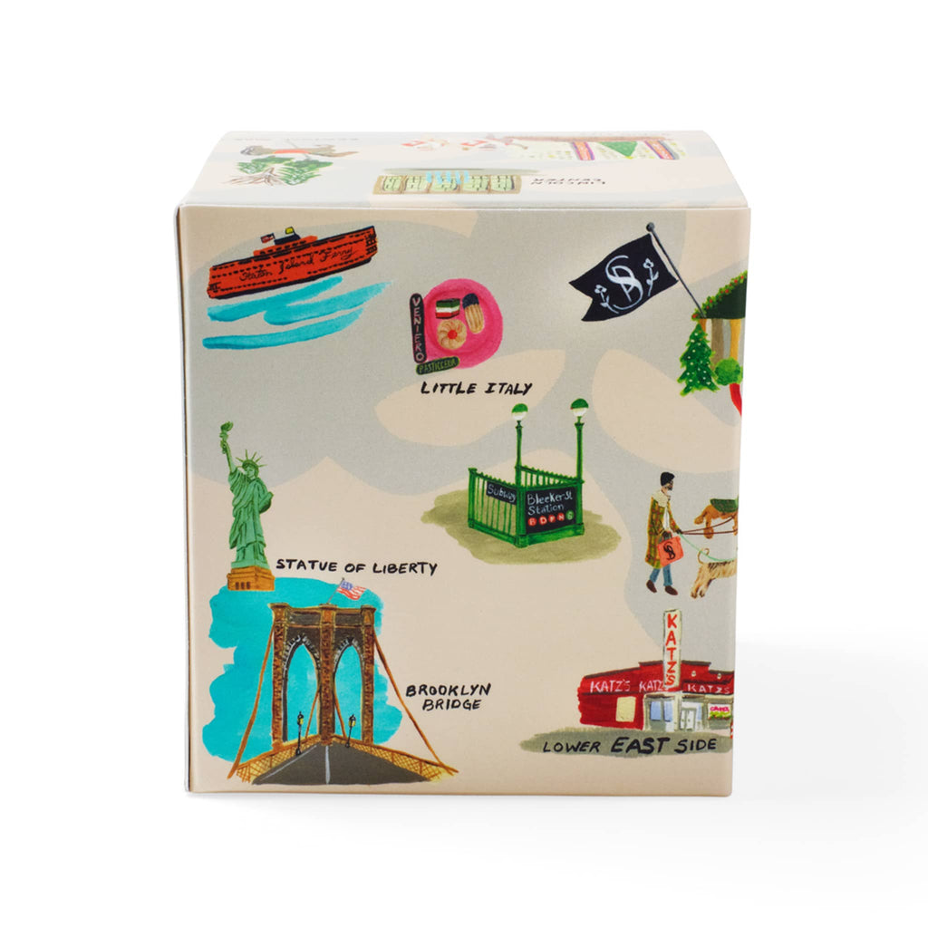 Soap & Paper Factory Roland Pine scented soy wax candle in gift box covered in NYC holiday illustrations, back view.