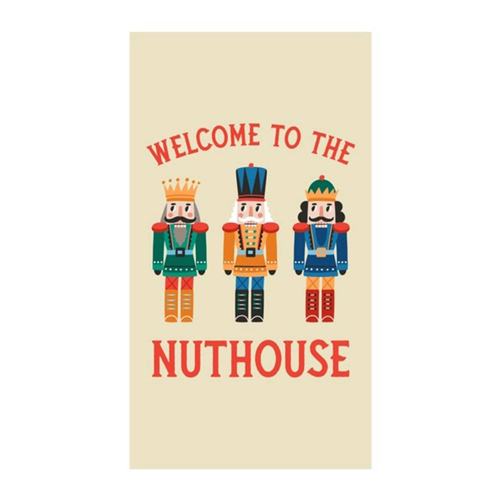 Beige paper guest towel with colorful nutcracker figures and "welcome to the nuthouse" in red lettering.