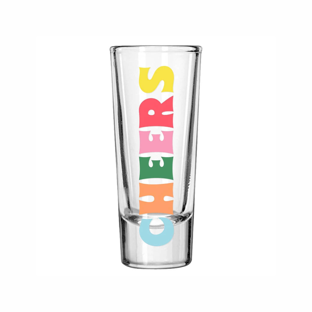 Clear glass shot glass with colorful 'CHEERS' text on a white background.