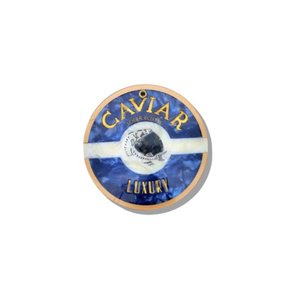 Solar Eclipse compact pocket mirror with caviar tin design, on a white background.