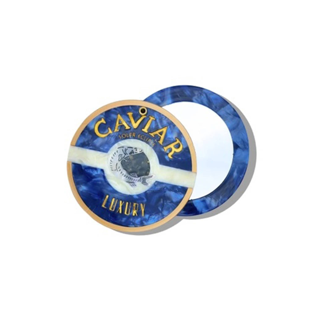 Solar Eclipse compact pocket mirror with caviar tin design, halfway open, on a white background.