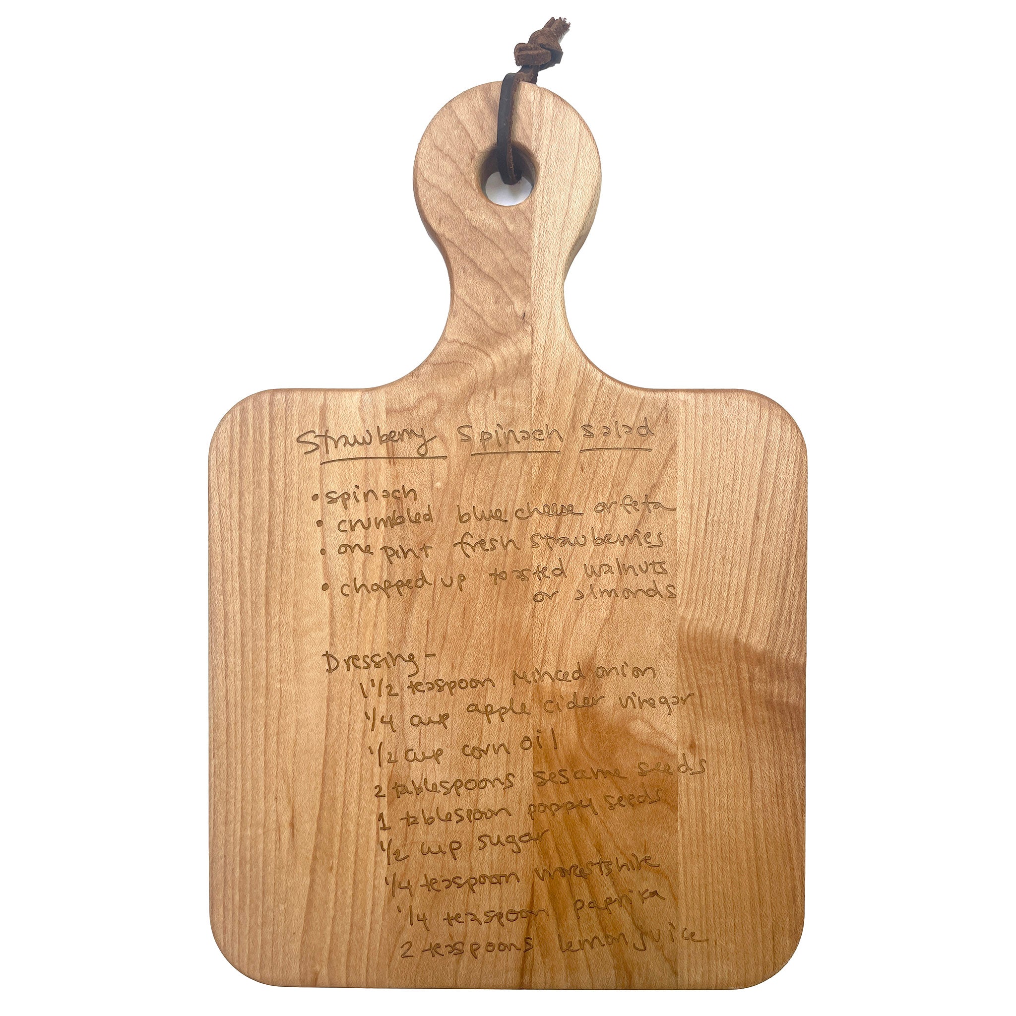 https://blueribbongeneralstore.com/cdn/shop/files/sophistiplate-maple-leaf-12x8-maple-artisan-serving-board-front-view-with-handwritten-recipe.jpg?v=1693597210